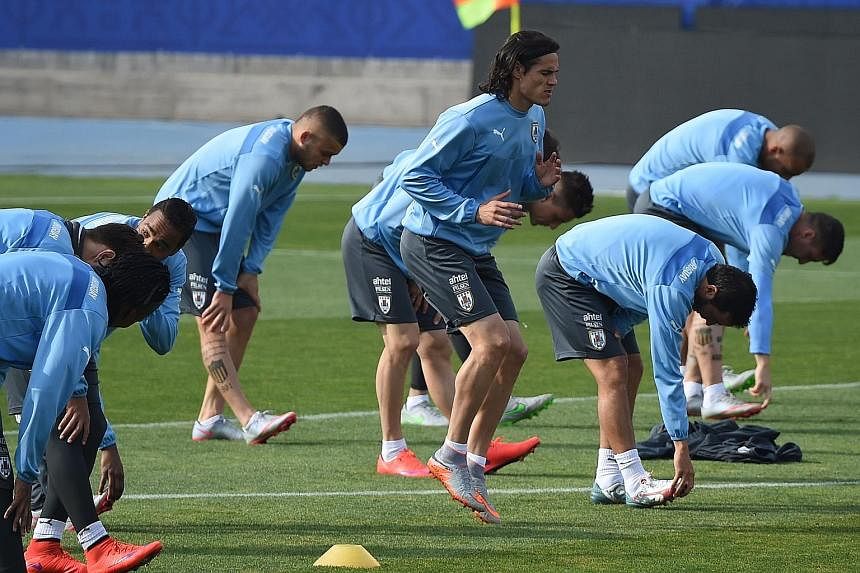 Uruguay forward Edinson Cavani (centre) and team-mates warming up before training in Santiago, where they face the hosts.
