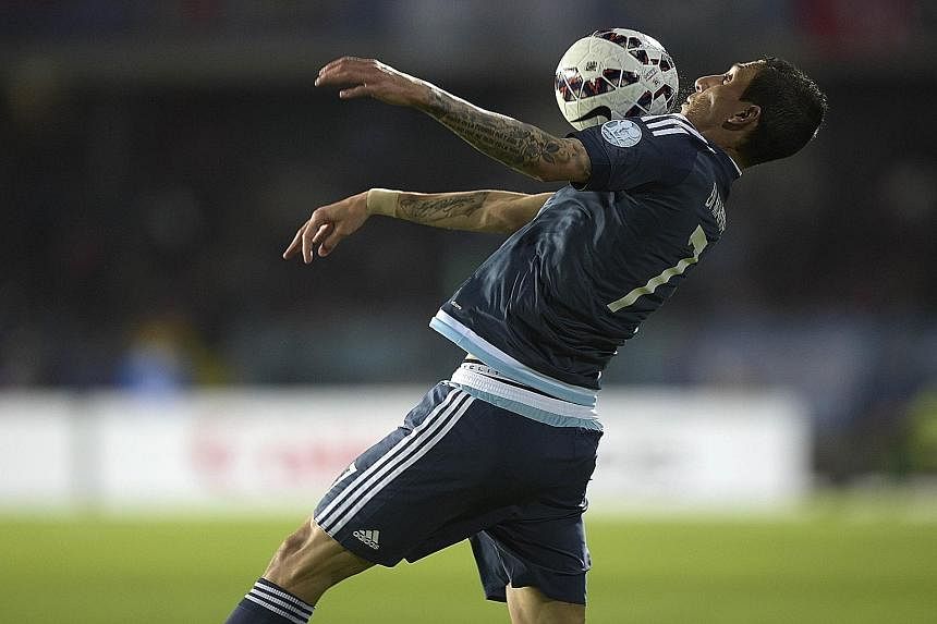 Argentina's Angel di Maria showing good control during the Copa America match against Uruguay. While he is frustrated at not playing all the time for United, he does not plan to leave them in the close season.