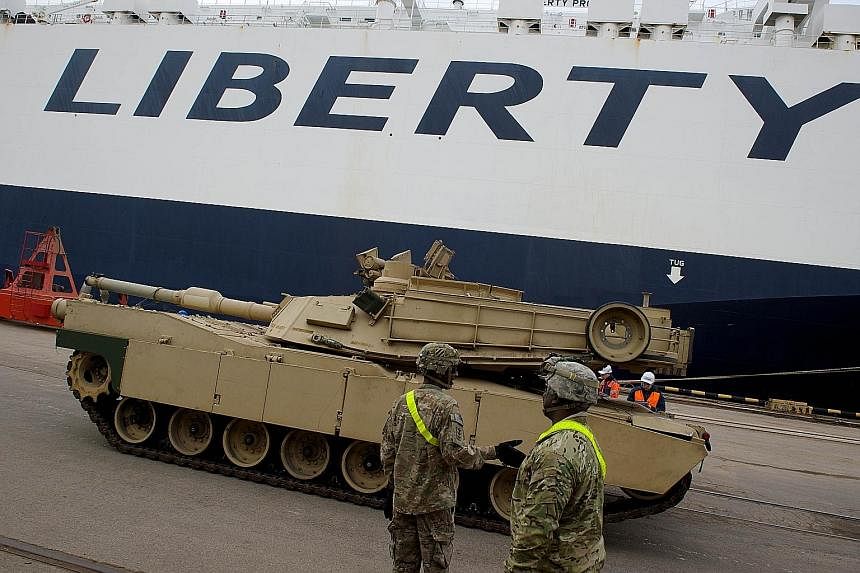 An Abrams tank being unloaded in Latvia in March. The US is deploying 90 Abrams tanks, 140 Bradley armoured vehicles and 20 self-propelled howitzers across Estonia, Lithuania, Latvia, Bulgaria, Romania and Poland for training and exercise purposes.