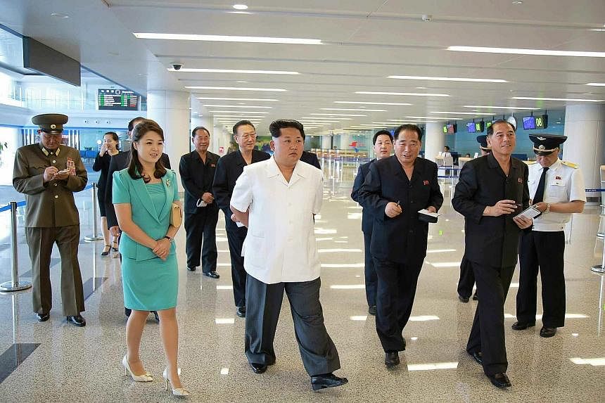 Pictures released yesterday by the Rodong Sinmun newspaper show North Korean leader Kim Jong Un (centre) and his wife, Ms Ri Sol Ju, inspecting the new terminal (below) at Pyongyang International Airport.