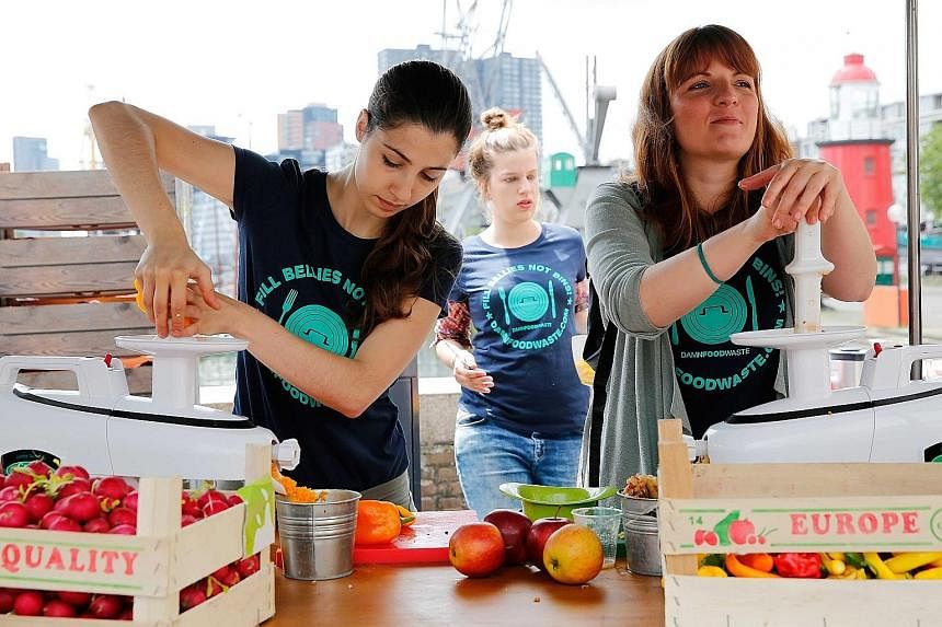Organisers preparing free lunches for visitors to the Damn Food Waste event in Rotterdam earlier this month. The Damn Food Waste organisation hoped to bring attention to food waste through the event, whose motto was "Fill bellies not bins".