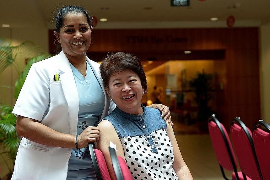Telemarketer Elsie Heng, who had a bout with breast cancer in 2011, with senior nurse clinician Patmavathy Chellaiyya, who looked after her when she was warded.