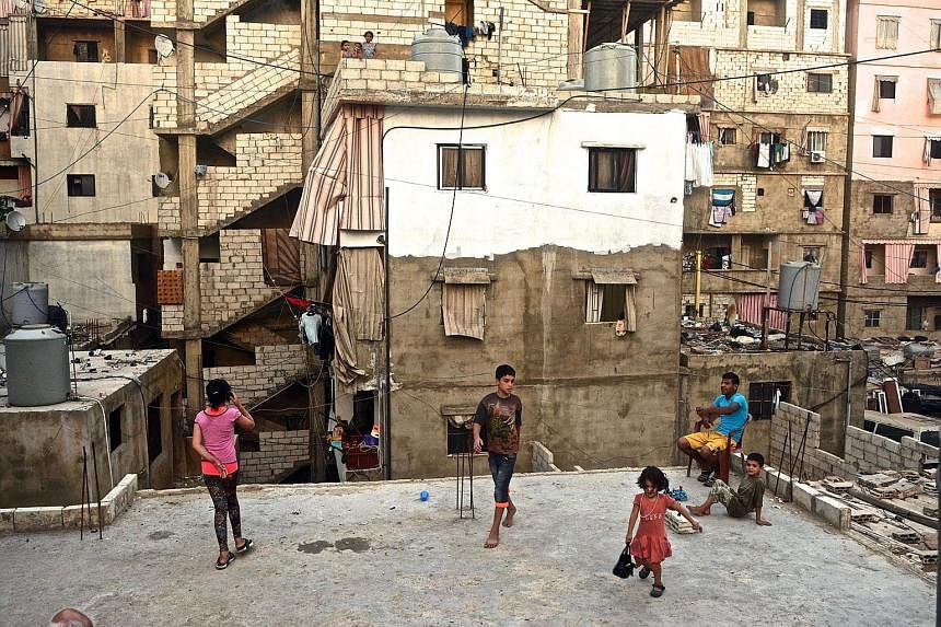 Palestinian children playing on the roof of an apartment block. Shatila was set up by the International Committee of the Red Cross to accommodate hundreds of refugees from northern Palestine who arrived after 1948. According to the United Nations Relief a