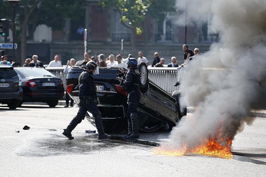 The busy Porte Maillot junction in Paris was one of several places hit by violence as taxi drivers clashed with Uber drivers on Thursday.