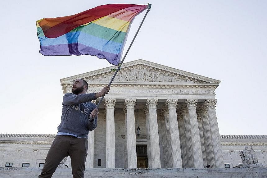 A gay rights flag flying high in front of the Supreme Court in Washington. The court ruled 5-4 yesterday that the Constitution's guarantees of due process and equal protection under the law mean that states cannot ban same-sex marriages.