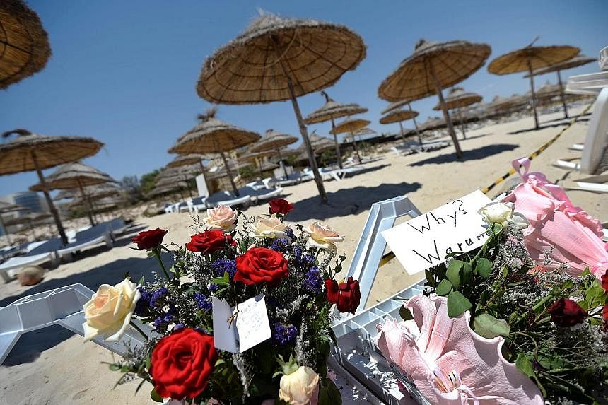 An undated image on Twitter posted yesterday by ISIS' Tunisian branch reportedly showing the gunman who carried out the deadly attack. Flowers and tributes to victims lay on a sun lounger at the Imperial Marhaba resort in Sousse, Tunisia, yesterday, 