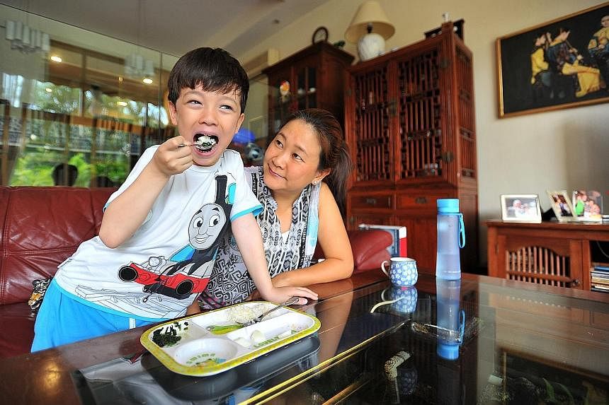 Ms Serene Lim gets her son Sebastien Geniaux (both left) to eat more varieties of food after sending him to a team of specialists, while Ms Sharifah Nurshida Syed Yahya took her daughter Ariana (both above) to a paediatrician. Ms Pauline Xie (below) 