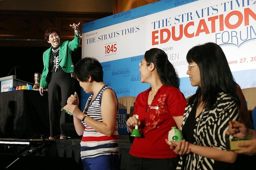 Mrs Carmee Lim, mentor principal of MindChamps Holdings, showing participants the importance of music, movement and dance in early childhood development at The Straits Times Education Forum yesterday.