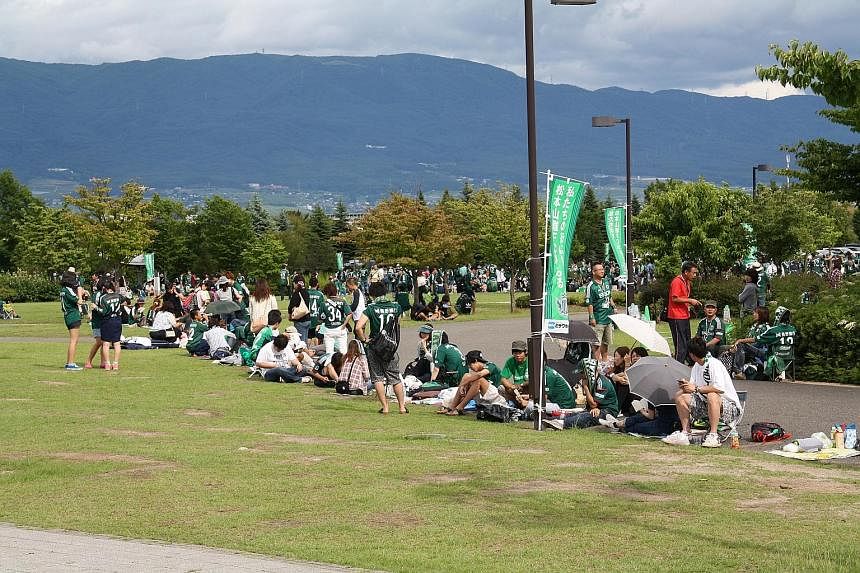 Yamaga fans paint the town green as they gather four hours before kick-off at the Alwin Stadium. Green banners are another sign of support while the local pubs serve green beer too.