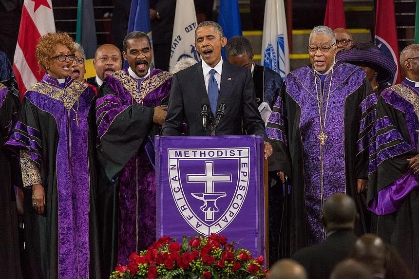Mr Barack Obama brought the 5,500 people at the service to their feet as he sang the first notes of Amazing Grace, with the audience swaying and singing with him.