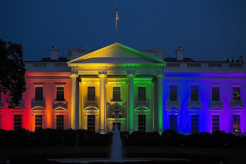 The White House illuminated at dusk in rainbow-coloured lights, the symbolic colours of gay pride, in Washington, DC on Friday.