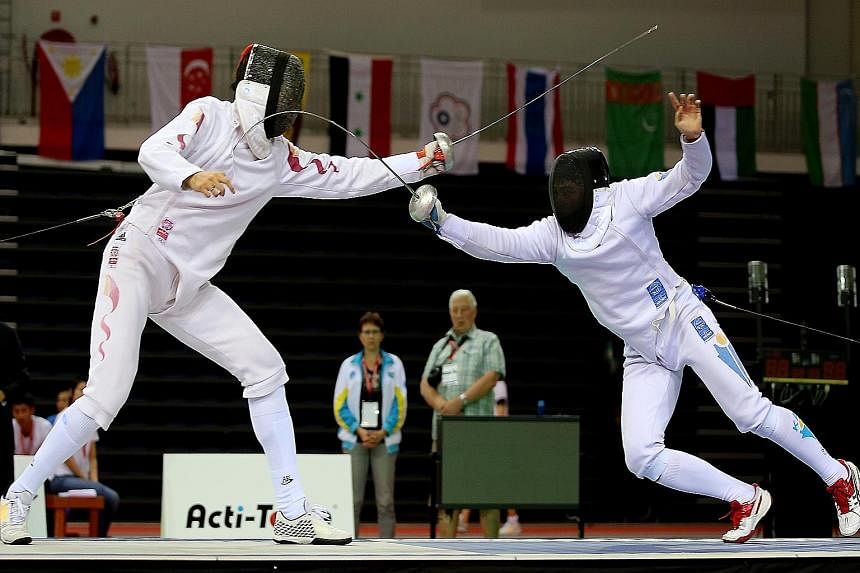 Kazakhstan's Ruslan Kurbanov (right) on the attack against China's Dong Chao. The Central Asians prevailed 45-43 in the epee team final.