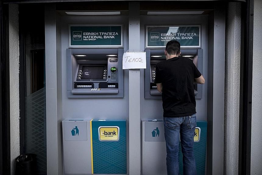 A handwritten sign that reads "End" is taped outside a bank in Greece. The country's failure to pay off its debt could lead to its exit from the euro zone economy which, in turn, would "undermine investor confidence in the longevity of the euro zone"