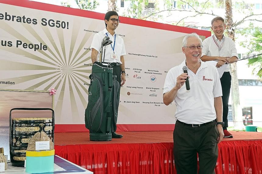 Emeritus Senior Minister Goh Chok Tong put up for auction his personal items, such as a set of golf clubs, to raise funds for vulnerable residents in Marine Parade at yesterday's carnival. Parliamentary Secretary for Health and Transport Muhammad Fai