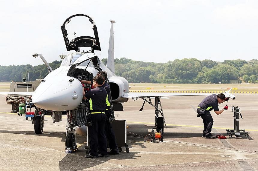 Servicemen of 144 Squadron performing an arming drill for the F-5S/T fighter aircraft. The squadron won the Best Fighter Squadron award for the fourth time, ousting its more modern F-15 and F-16 counterparts. The RSS Tenacious clinched the Best Fleet