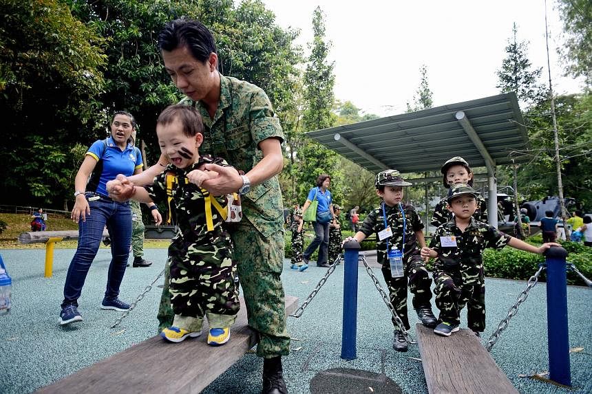 Pre-schoolers from NurtureStars having a go at a miniature version of an obstacle used in the SAF's Standard Obstacle Course, during a visit to the Singapore Discovery Centre yesterday.