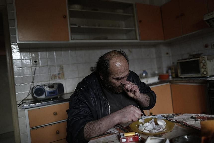 WHEN PENSION ENDS: For Mr Iakovos, 41, a home-cooked meal was still within reach when his mother was alive and drawing a pension. After she died in 2012, the Athens resident has been collecting aluminium cans but is unable to make a living. (Clockwis