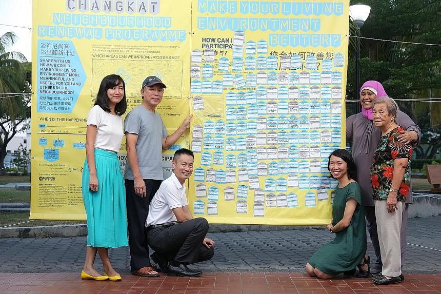 Participate in Design founders Mizah Rahman (left) and Jan Lim (third from right), with Tampines Changkat residents (from left) Tan King How, Chong Kok Yeow, Suzana Ahmad and Liew Fook Wu, with a canvas board displaying the written views of residents