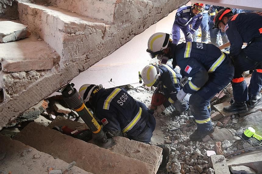 In Nepal, SCDF officers used struts to keep a collapsed stairwell up while they looked for a man buried under the rubble.