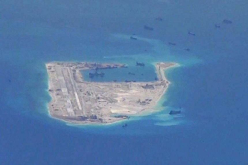 (Above) A picture from the US Navy purportedly showing Chinese dredging vessels in the waters around Fiery Cross Reef where the 3,000m airstrip is being built. (Left) Satellite images taken this year, showing the artificial island that was rapidly bu