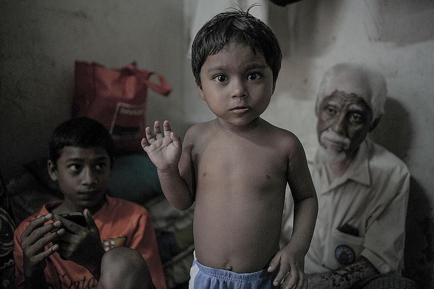 A Rohingya child inside a house in the suburbs of Kuala Lumpur. Malaysia has been the main destination for many illegal migrants.