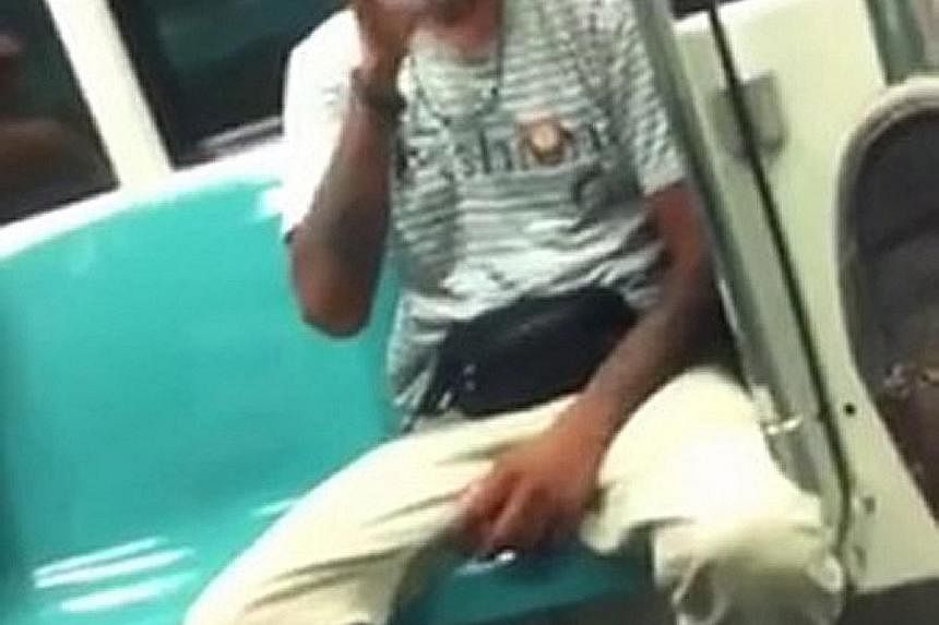 One of the two men who were seen in an online video taking turns to puff on a cigarette while on board an MRT train at night.