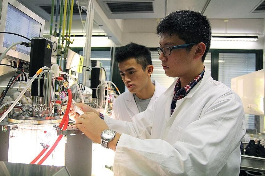 Students Indra Putra Kamsan (left) of Millennia Institute and Malcom Lau of Temasek Polytechnic working in a laboratory at the Technical University of Munich in Germany last month. During their stint, they carried out experiments under the supervisio