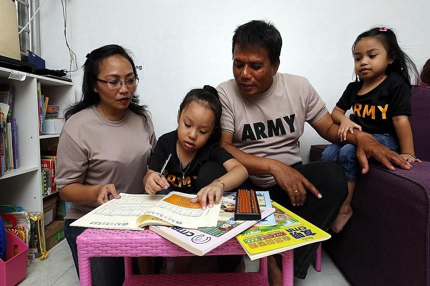Madam Siti Zubaidah, 41 (left), sends her daughter Amelia Shasmeen Azman, five (second from left), for English phonics and reading classes as well as weekly abacus lessons. With them are Amelia's father, Mr Azman Rahmad, 50, and her sister Alisha Mia