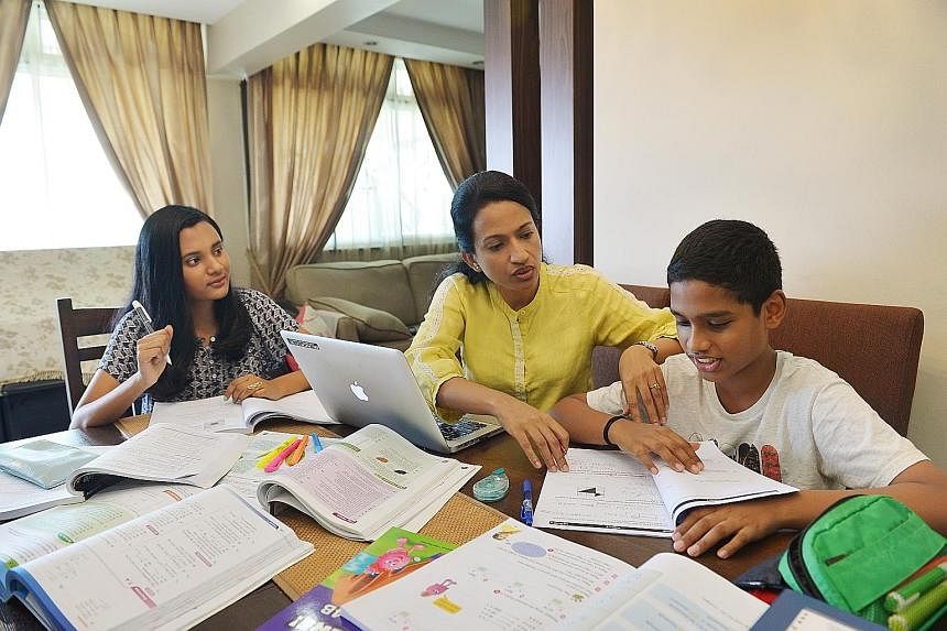 Madam Sujata Devi (centre) with her daughter Annushiyaa (left) and son Anirudh at home. The fees for their tuition lessons add up to over $1,500 a month, up from about $700 last year.