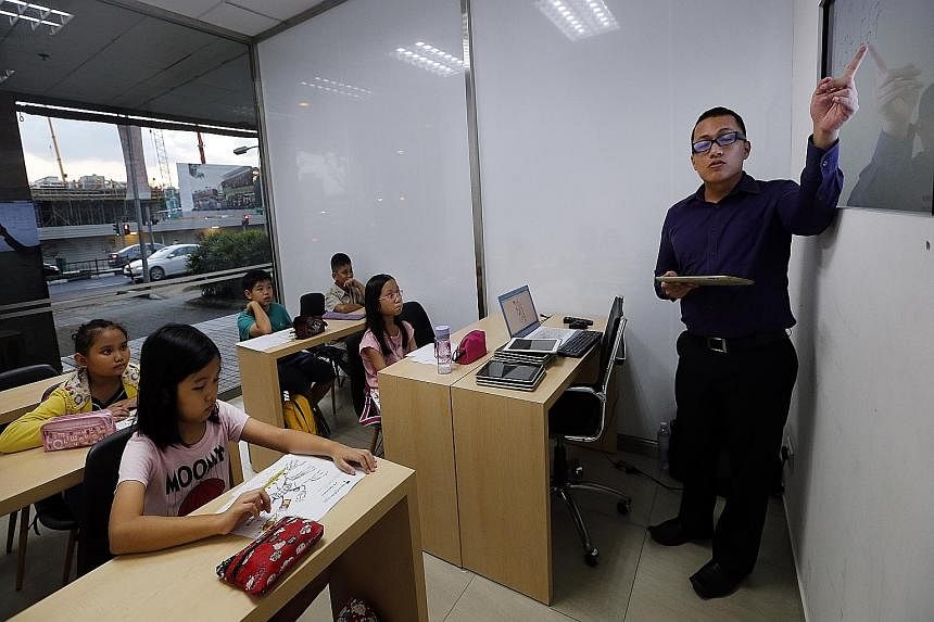 Maths tutor Diaz Adi Utama, 27, teaching a class. Parents often find it necessary to send their children for tuition in maths, especially at the higher levels, because the subject is too technically taxing for them to coach personally.