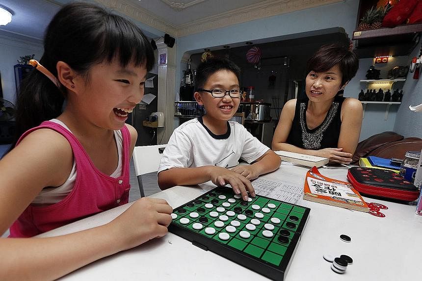 Housewife Michelle Chen admits her children's academic results are not ideal. Vivian (left) and William struggle with maths and science, but Madam Chen says the children have to tackle this problem themselves.