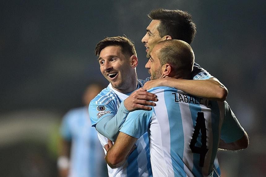 Argentina's midfielder Javier Pastore (centre) celebrating with team-mates Lionel Messi (left) and Pablo Zabaleta after scoring against Paraguay in the semi-final. Argentina can bounce back quickly from last year's World Cup disappointment with a Cop