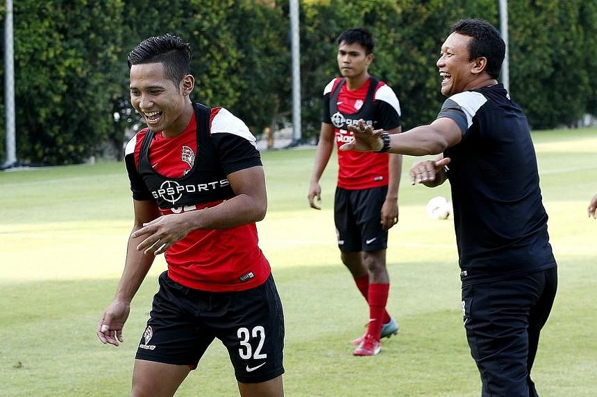 LionsXII forward Sahil Suhaimi (left) sharing a joke with coach Fandi Ahmad during training at the Geylang field. The Singapore side were winless in their last two MSL games.