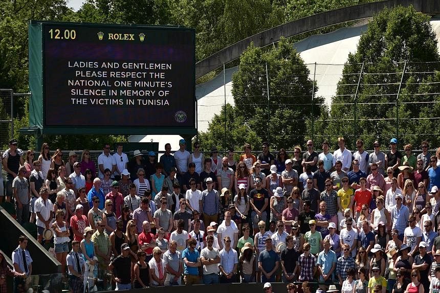 Spectators and staff at the Wimbledon tennis tournament observing a minute's silence yesterday in memory of the British victims of the June 26 Tunisia attack as Britain marked an official day of mourning.