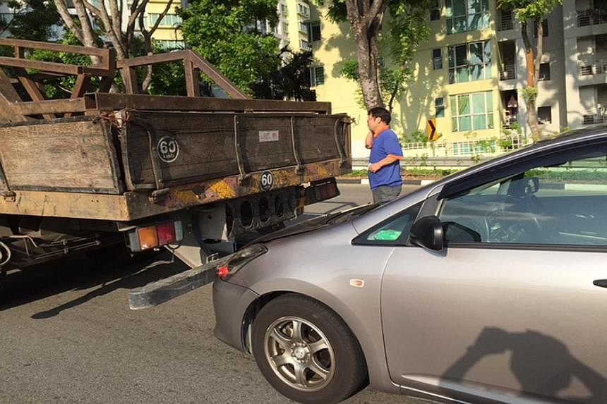 Ms Paulla Lee alleged that the lorry rolled back and rammed into her car despite her sounding the horn. She claimed the driver promised to pay for the damage, but is uncontactable.