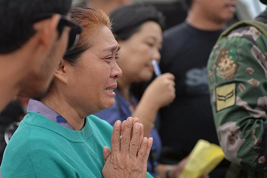 A relative of a victim weeping as rescuers ended their search for survivors yesterday. The sea was calm when the ferry capsized on Thursday.