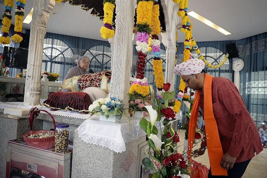 Deputy Prime Minister Tharman Shanmugaratnam paying his respects at the Bhai Maharaj Singh Memorial Temple during the Bhai Maharaj Singh Festival at the Silat Road Sikh Temple yesterday.