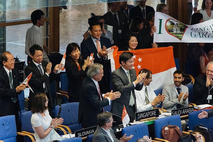 Singapore's delegation led by Minister for Culture, Community and Youth Lawrence Wong (centre) applauding the World Heritage Committee's decision to list the 156-year-old Botanic Gardens as a Unesco site during its 39th session in Bonn, Germany yeste