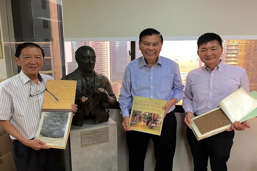 Rubber pioneers (from left) Teddy Chua, Peter Tan and Lim Kok Eng beside a bust of the gardens' first scientific director, Sir Henry Nicholas Ridley, at the Rubber Trade Association of Singapore's office. Mr Tan is holding a book he has written on ru