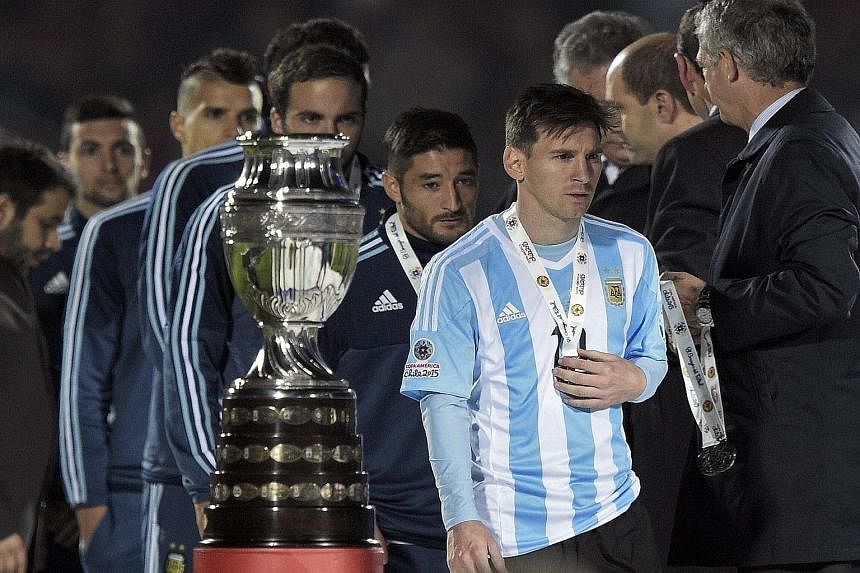 Argentina players, led by captain Lionel Messi, walking off the podium after receiving their Copa America silver medals, following a 1-4 loss in the penalty shoot-out to hosts Chile in Santiago.