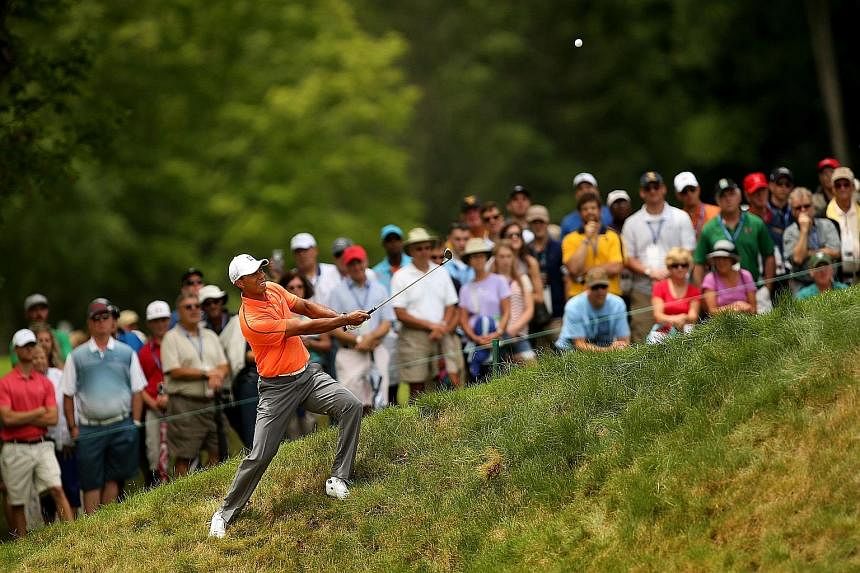 Tiger Woods hitting his second shot from a slope on the eighth hole in the third round of the Greenbrier Classic. Nick Faldo sees continued problems with Woods' swing.
