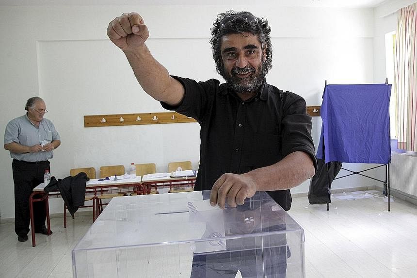 A Greek on the island of Crete casting his vote yesterday.