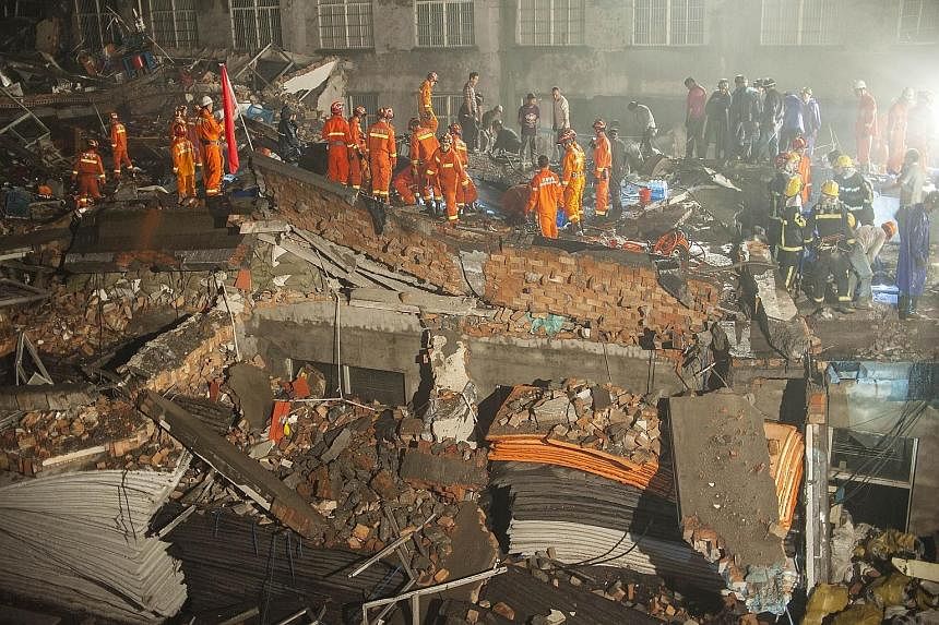 Rescuers looking for survivors among the debris of the collapsed shoe factory in the city of Wenling in Zhejiang province.