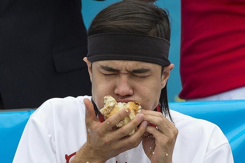 Mr Matt Stonie chomping his way to becoming champion of the annual Fourth of July Nathan's Famous Hot Dog Eating Contest in Brooklyn, New York.