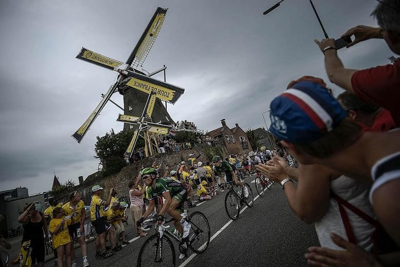 France's Thomas Voeckler rides past a windmill as supporters cheer during the 166km second stage of the Tour de France. BMC team's Tejay van Garderen is ahead of the favourites for now.