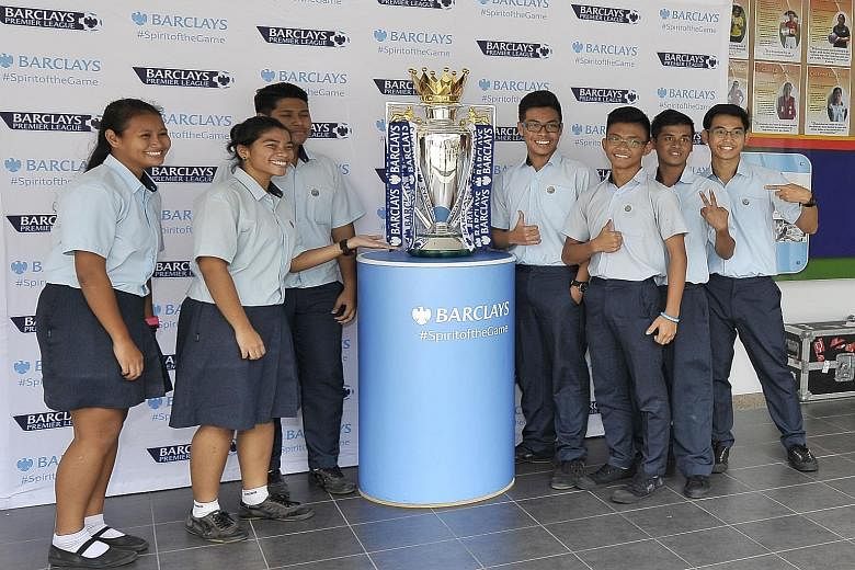 No Monday blues at Hong Kah Secondary as excited students pose for pictures with the Barclays Premier League trophy won by Chelsea last season.