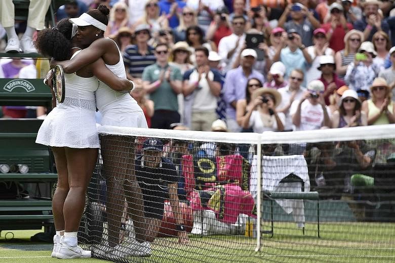 Serena Williams (left) embracing sister Venus after winning their fourth-round tie yesterday. It was her 14th victory in 26 meetings and keeps her on course for a sixth Wimbledon title.