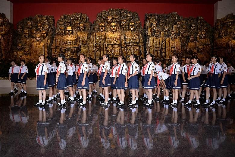 Students visiting the exhibition called "Great Victory, Historical Contribution" at the museum, which features 1,170 photographs and 2,834 historical relics.