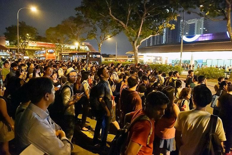 Commuters outside Bishan MRT station (far left) waiting for buses after train services were disrupted last night. Over at City Hall MRT station, commuters snapped photos of a signboard displaying information on the disruption of services on the East-