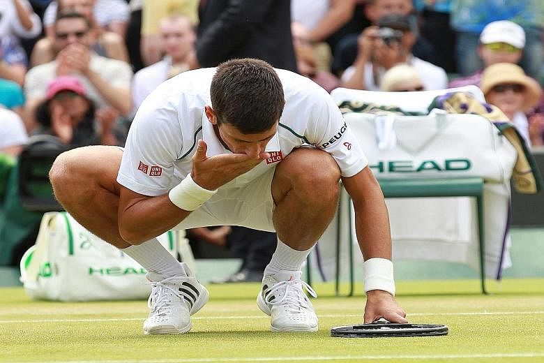 Novak Djokovic celebrates his victory over Kevin Anderson by kissing the Wimbledon turf. He had a great escape after coming back from two sets down.